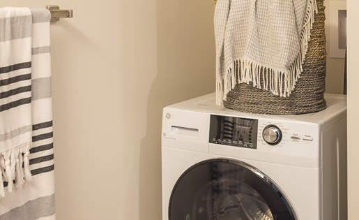 a washing machine with a basket on top of it