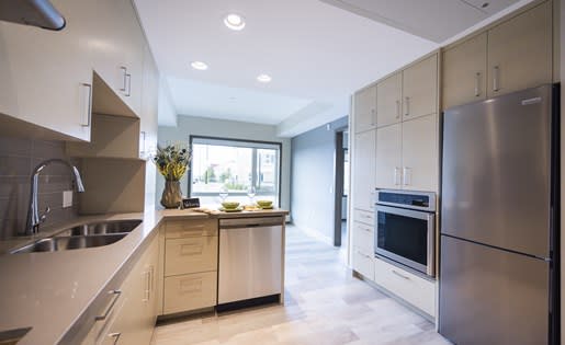 a kitchen with a sink stove and refrigerator