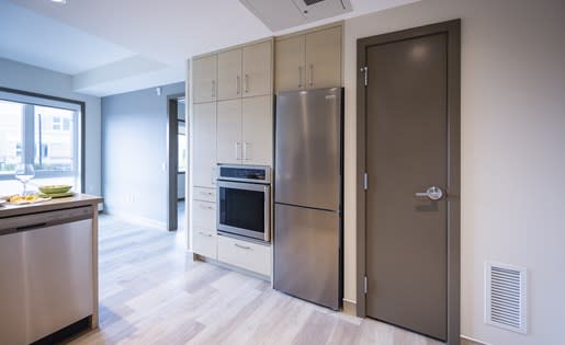 a kitchen with a refrigerator and a stove
