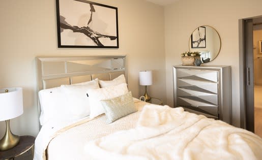 a bedroom with a bed and a dresser