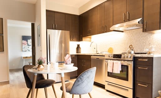 a kitchen with a stove top oven next to a table