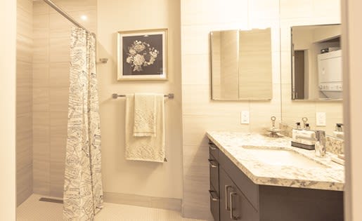 a bathroom with a shower sink and mirror