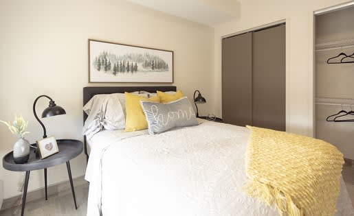 a bedroom with a white bed and yellow pillows