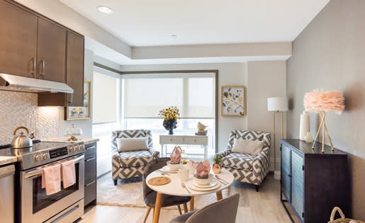 a kitchen and living room with a table and chairs
