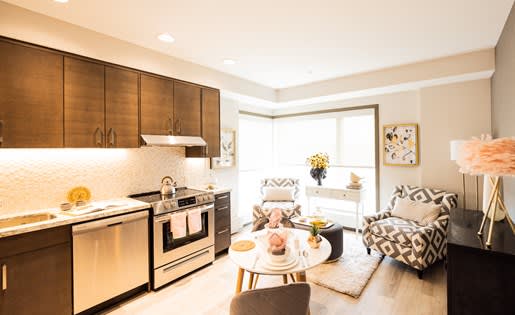 a kitchen and living room with a table and chairs