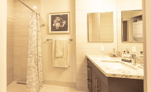 a bathroom with a shower sink and mirror