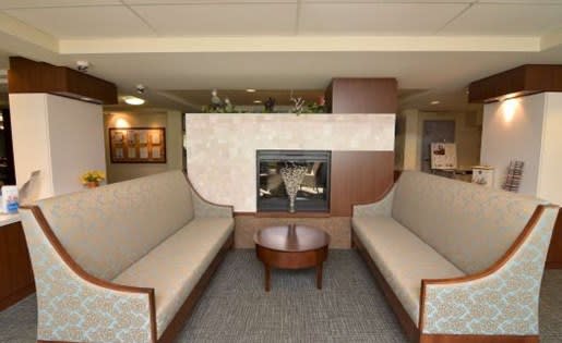 a living room with couches a table and a fireplace