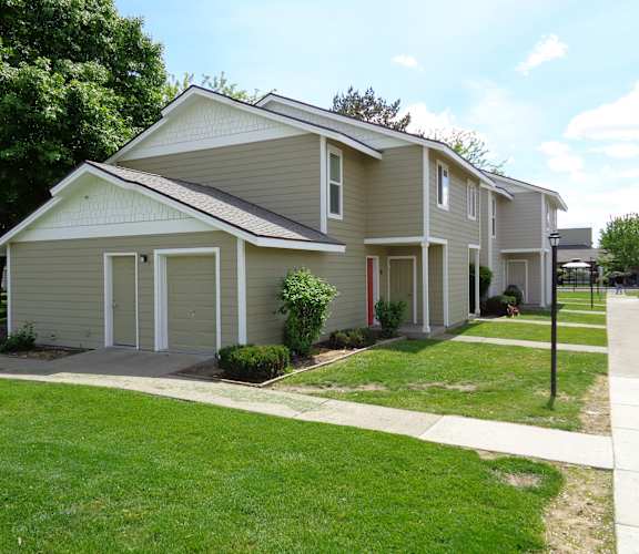 A two-story house with a grey roof and white trim.