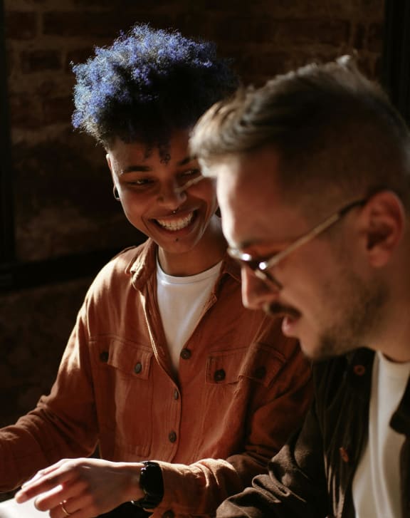 a man and woman sitting at a table talking  at Zelia on Seven, St Louis Park, MN, 55416