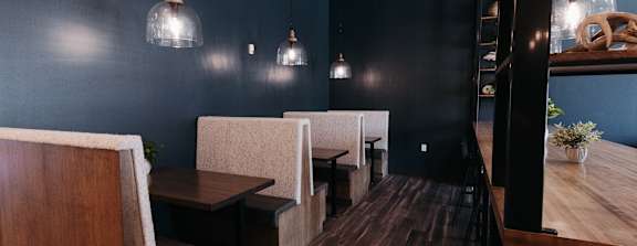 a dining room with a wooden table and stools