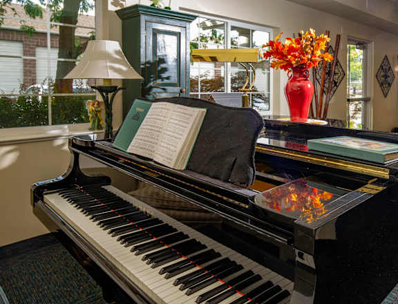 a piano with a book on it in a lobby