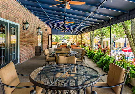 a patio with tables and chairs and a blue ceiling