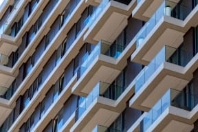 the facade of a building with balconies and windows