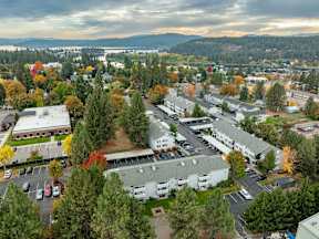 A view of a parking lot and buildings from above. at Ironwood Apartments, Coeur dAlene, ID
