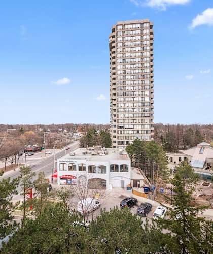 an aerial view of a tall building with a blue sky in the background