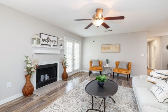 a swimming pool with chaise lounge chairs and a pool house in the background  at Laurelwood Apartment Homes, Laurel, MS