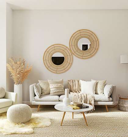 a living room with a couch and mirrors on the wall