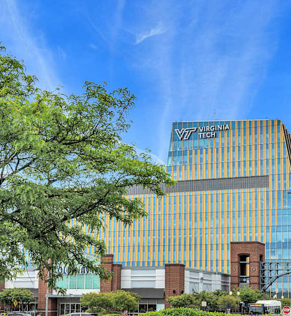 A modern building with a glass facade and the words "Virginia Tech" on it.
