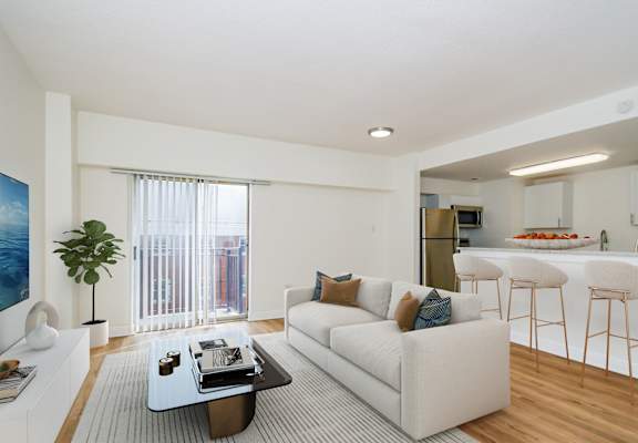 A modern living room with a white couch and a coffee table.