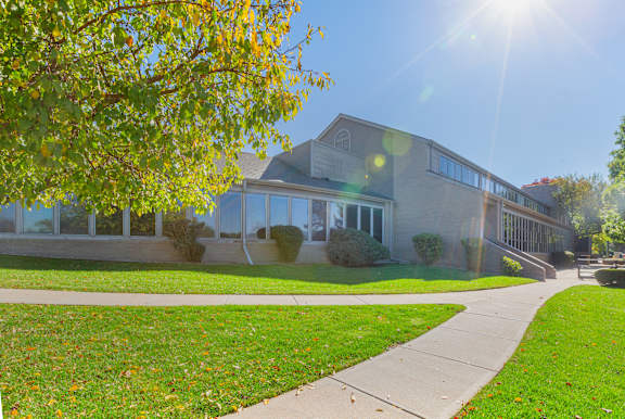 A building with a green lawn in front of it.