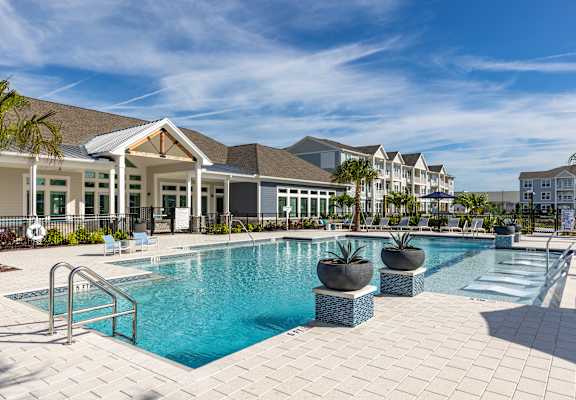 a swimming pool with a building in the background