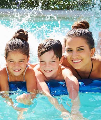 a family in the water in a swimming pool
