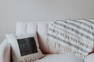 a white couch with a black and white throw pillow