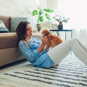 a woman laying on the floor with her dog