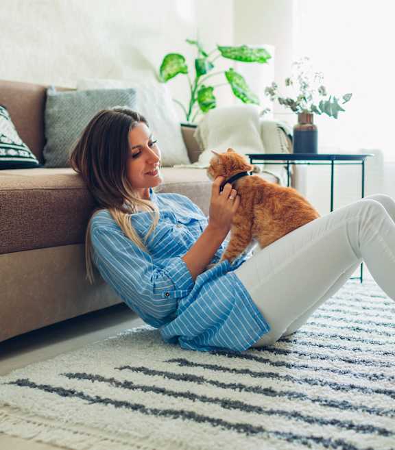 a woman laying on the floor with her dog