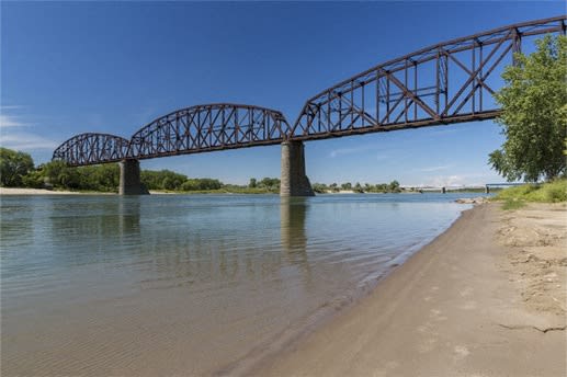 a bridge over a body of water and a beach