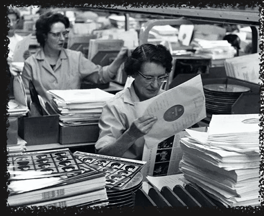 a woman is reading a piece of paper