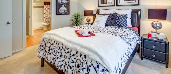 a bedroom with a large bed and a ceiling fan