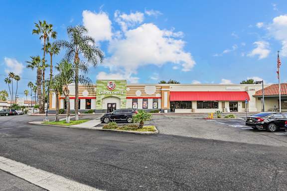 A large building with a red roof and a sign that says "Garden Center" in front of it.