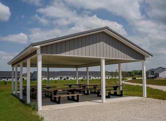 a pavilion with picnic tables under it