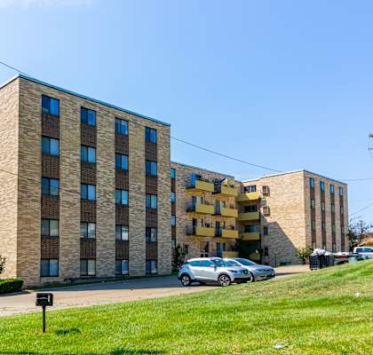 a large brick apartment building on a city street