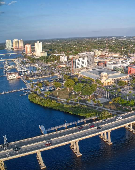 A cityscape with a bridge over a body of water.