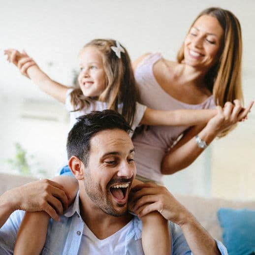 a man sitting on a couch with his family