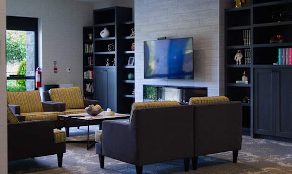 a living room with couches and chairs and a television