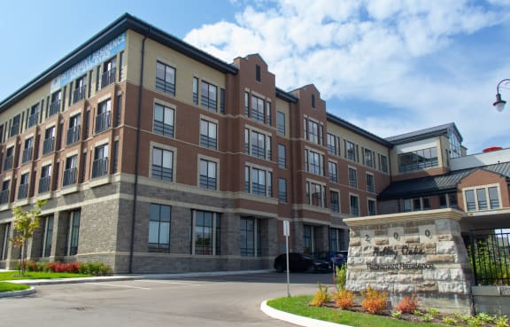 Ashley Oaks Retirement Residence. Picture shows a large brick building with a gazebo in front of it