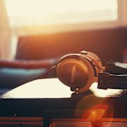 A pair of headphones rests on a turntable.