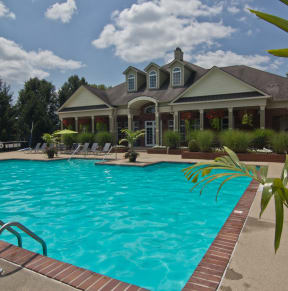 a swimming pool with a house in the background