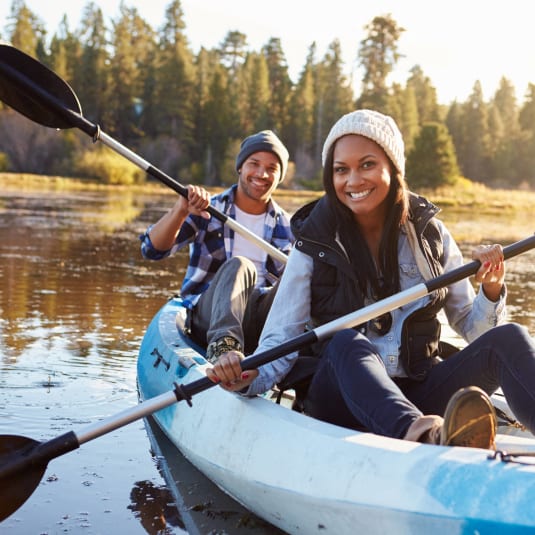 two people in kayaks on the water on a lake