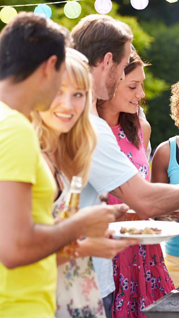 A group of people are gathered around a barbecue grill.at Valencia Trace, ORLANDO, 32825