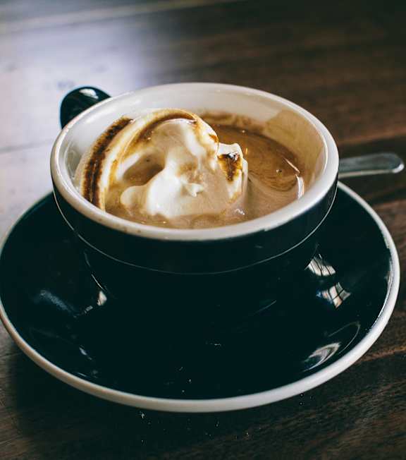 a cup of coffee with whipped cream on top