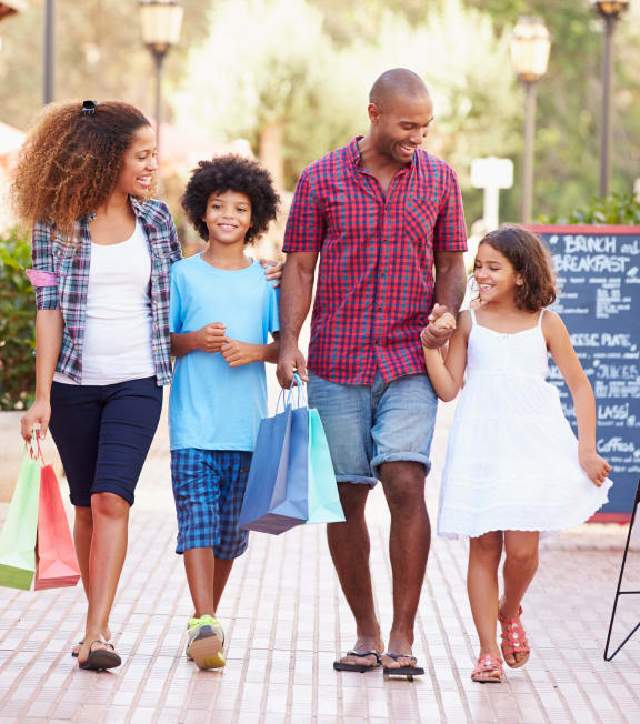 a family walking down the street with shopping bags at Oakridge Apartments, Antioch, 94509