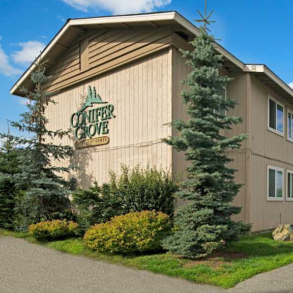 The exterior sign and building of Conifer Grove. 