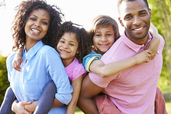 a family of four smiling at the camera