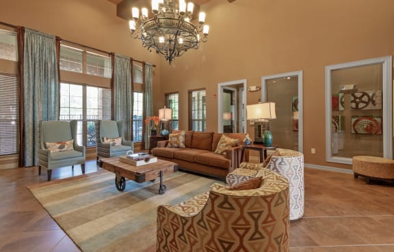 a living room with furniture and a chandelier