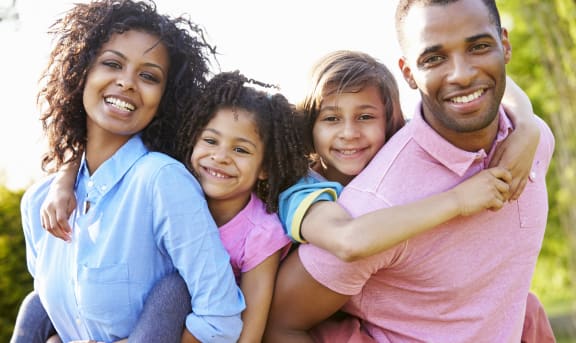 a family of four smiling at the camera