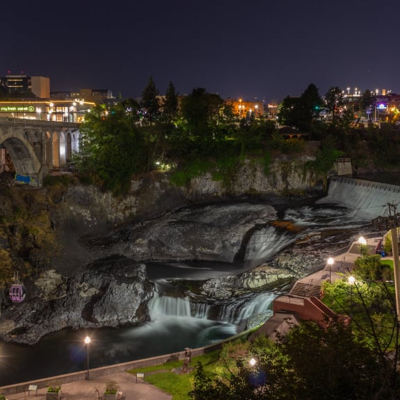 a view of the falls at night with the bridge over it